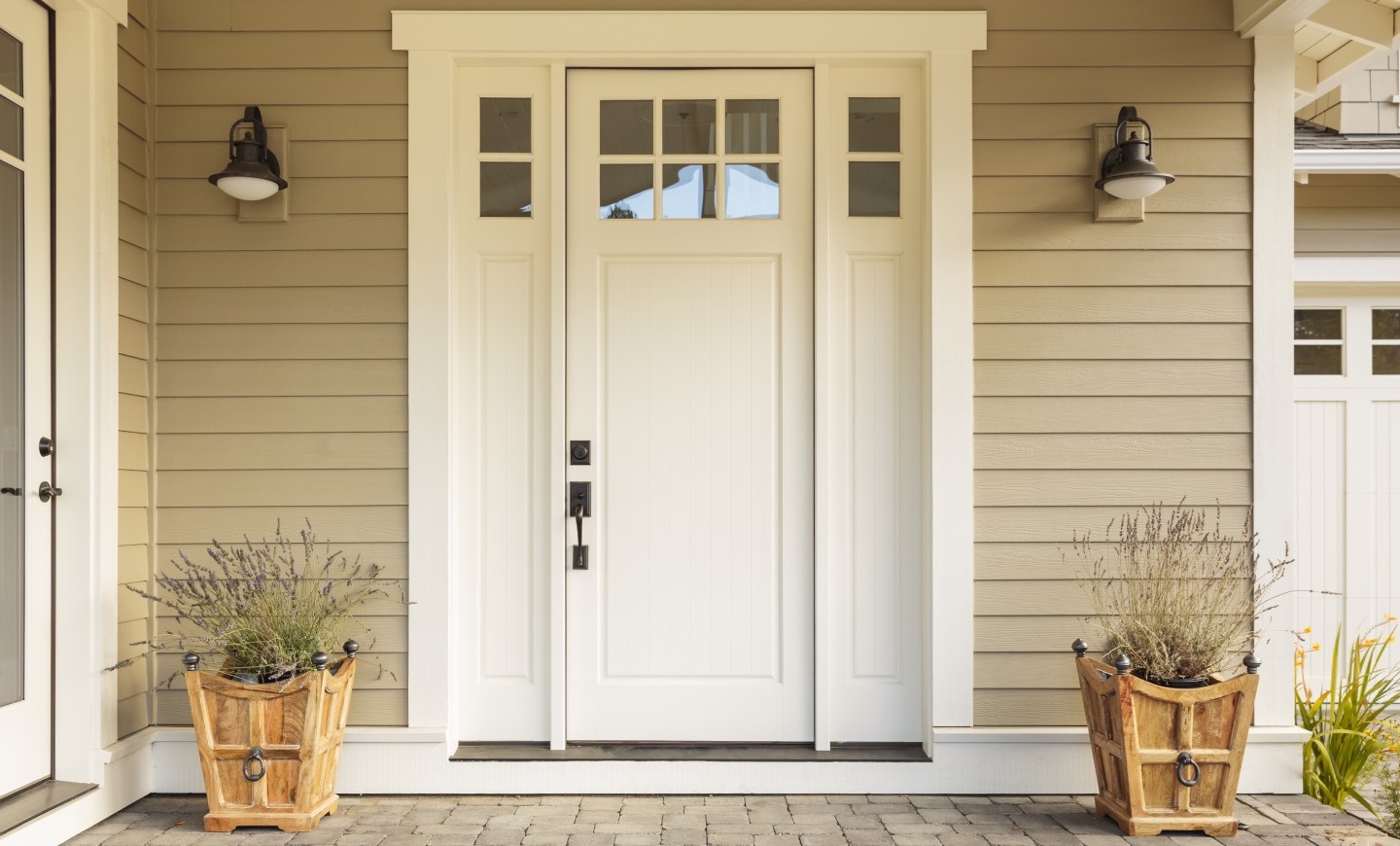 White front door with small square decorative windows and flower pots citrus heights ca